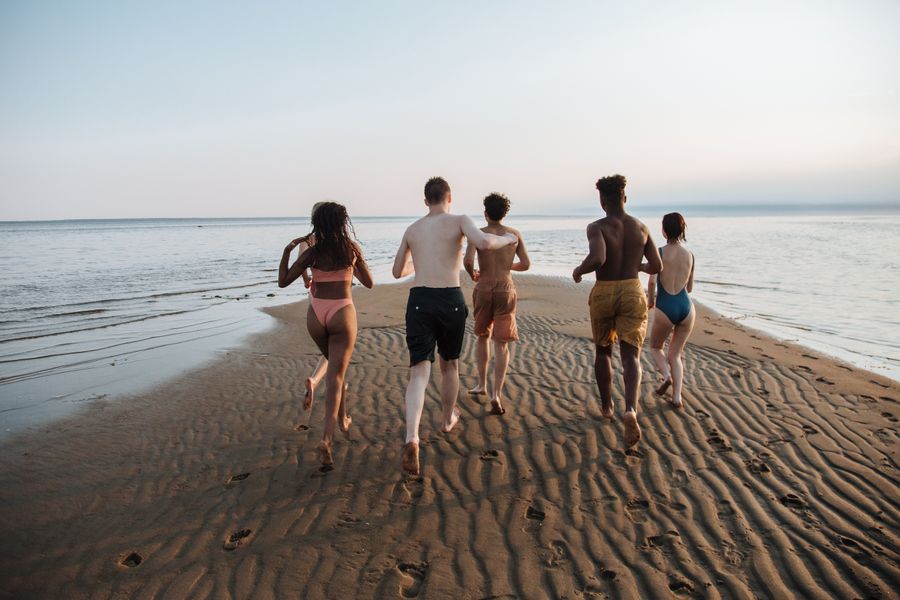teenagers running towards sea — Data Usage Estimator: built for the airport sprinter and the careful planner alike.