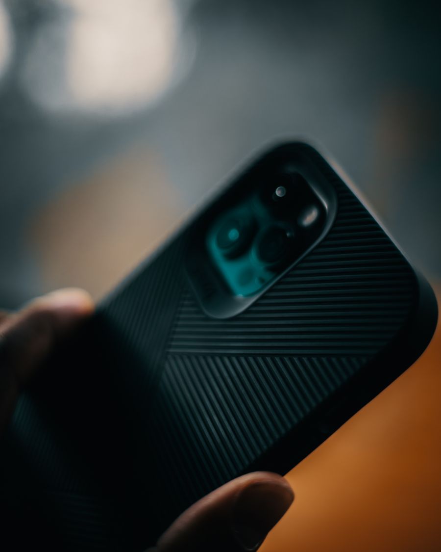 a person holding black smartphone — Plazas and promenades: video calls home with the view behind you.