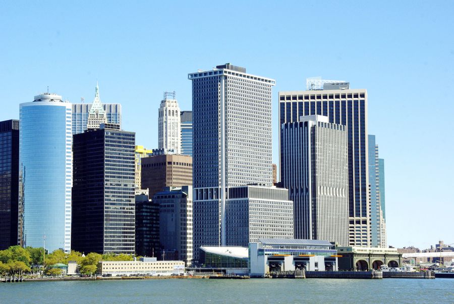 white and gray high rise buildings near body of water