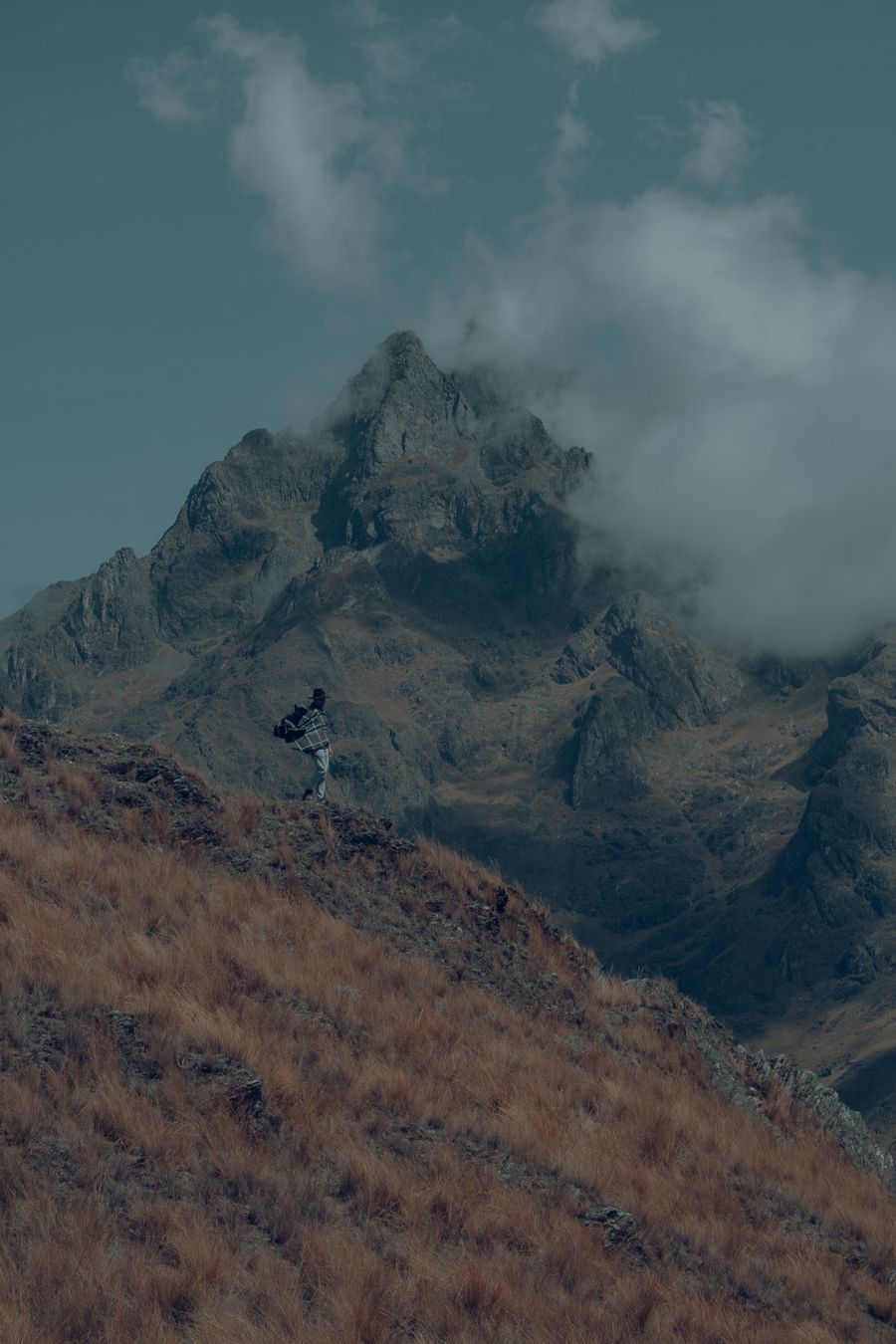 man with a backpack standing on a mountain slope — Lost in the medina, found by GPS: the blue dot never lies.