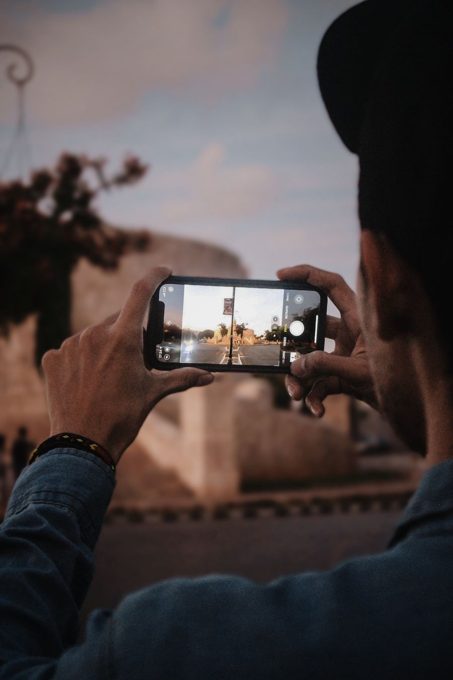 Man takes a photo of Mérida, Mexico with smartphone, capturing scenic view. — Public Wi-Fi Security Checklist runs in your browser session — nothing sensitive stored against you.