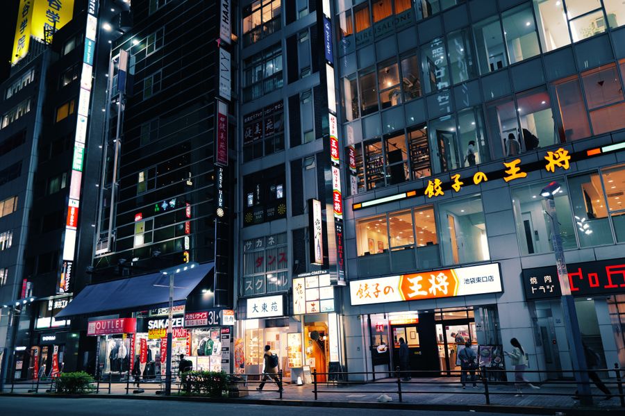 buildings and people in city at night