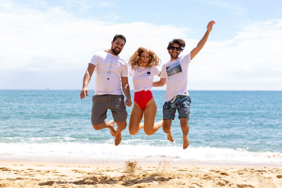two men and one woman jumping near shore — As filas de check-in andam mais rápido quando seus documentos estão no celular.
