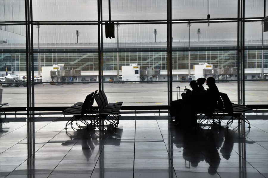 people sitting on chairs in airport — Docs: Centro, conectado: o eSIM encontra sozinho a rede local mais rápida.