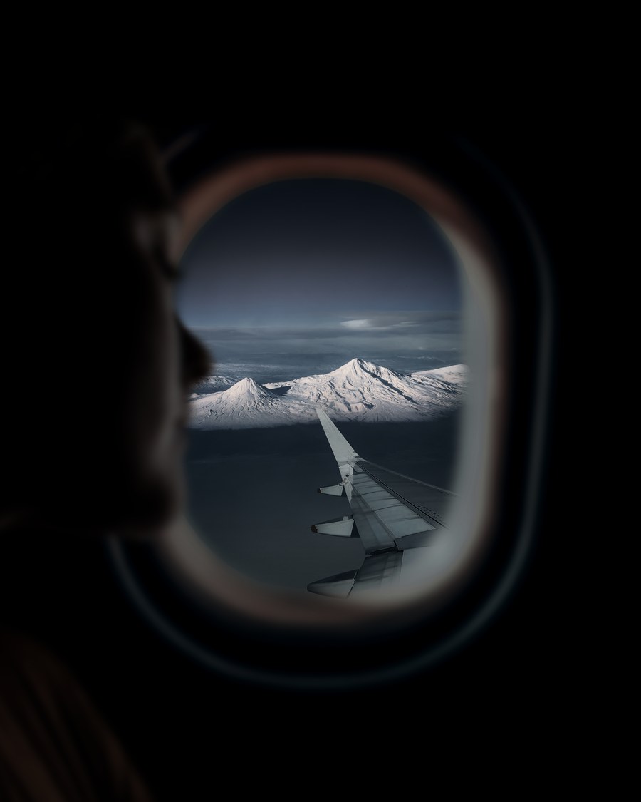 snowy mountains view from airplane window — Old town, new tricks: translation apps working in real time.