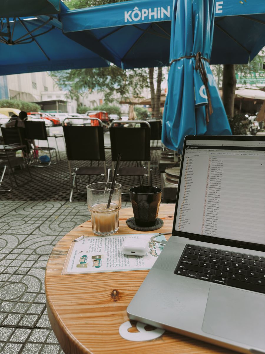 laptop and coffee at outdoor cafe workspace — The long layover: streaming, working and messaging, all covered.
