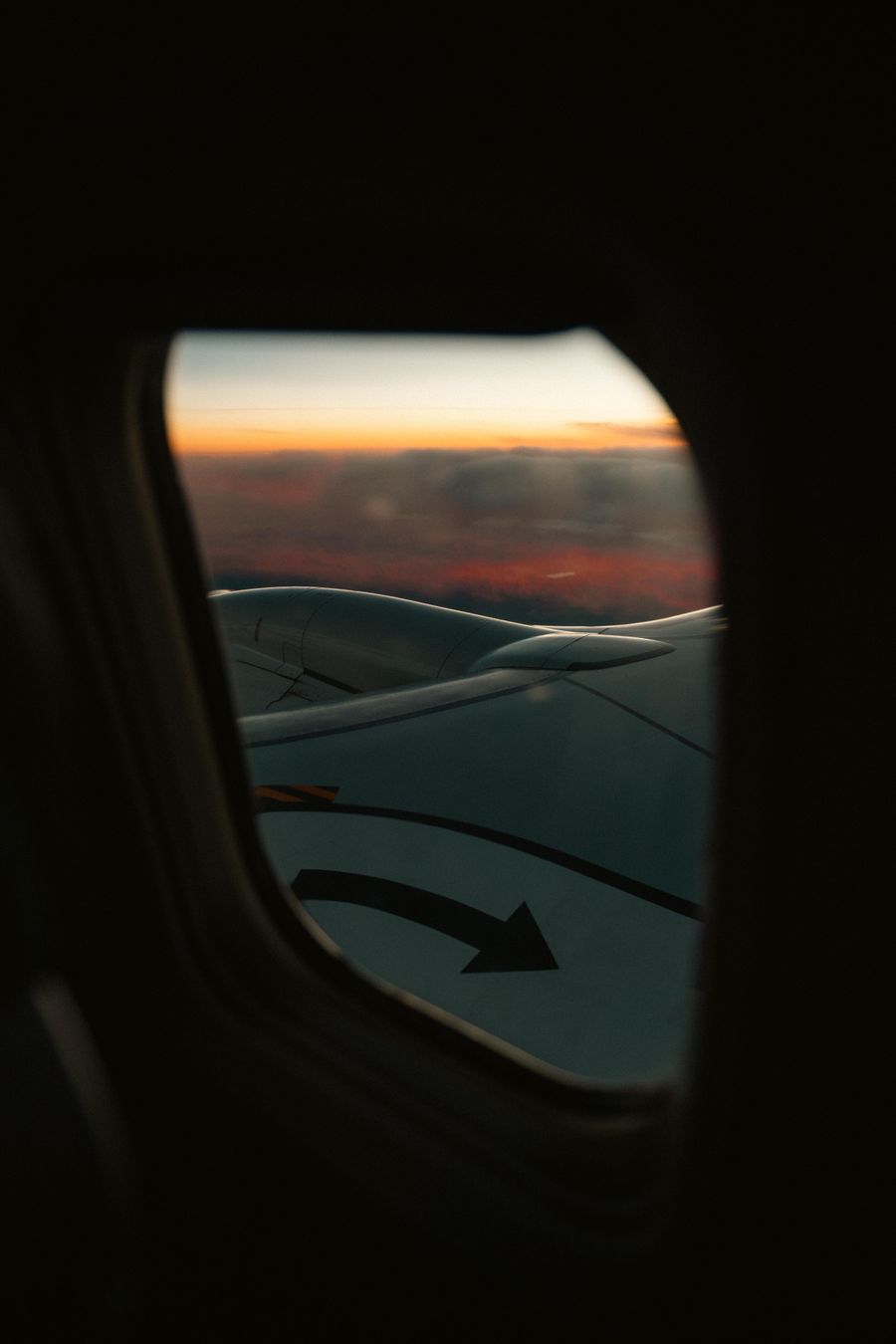 view from airplane window at sunset — The commute, handled: podcasts downloaded, messages sent, no dead zones.