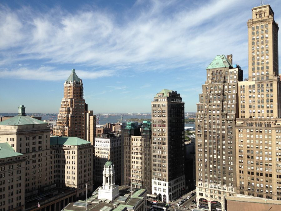 view of brown and grey high rise building — Check-in no terraço: cartões de embarque e chaves do hotel, tudo no celular.