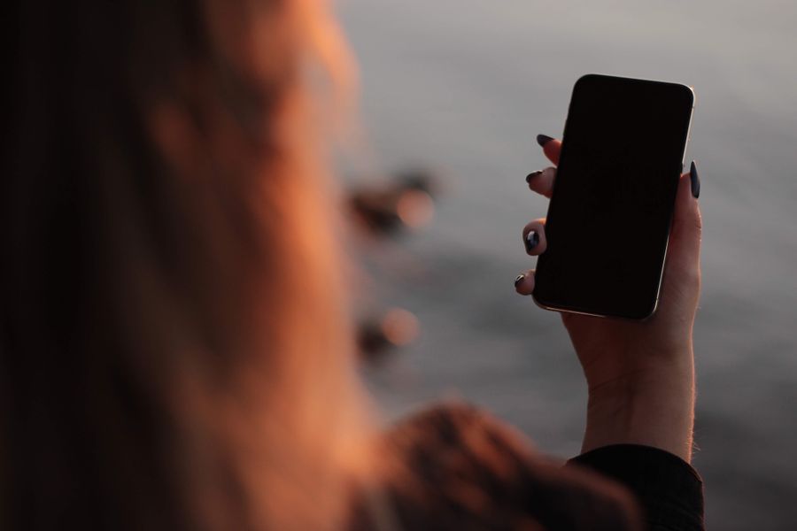 woman holding iphone in hand