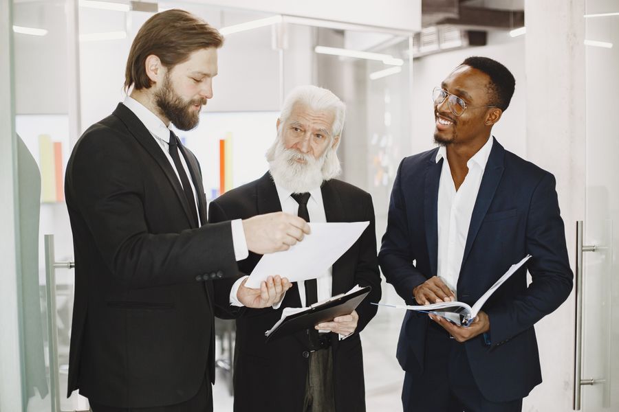 men in suits — Check-in lines move faster when your documents are on your phone.