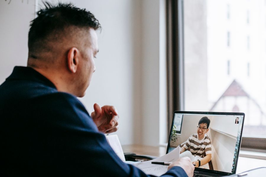 photo of men talking through laptop — Connection Quality Grader computes the moment you submit — no queues, no waiting room.