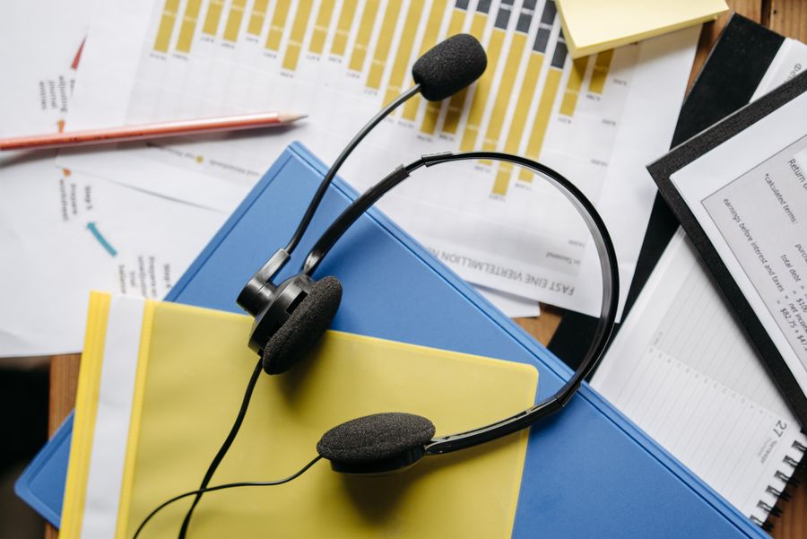 a close up shot of a headset on documents