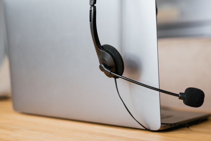 close up shot of headphones hanging on a laptop — APN Settings Lookup runs in your browser session — nothing sensitive stored against you.