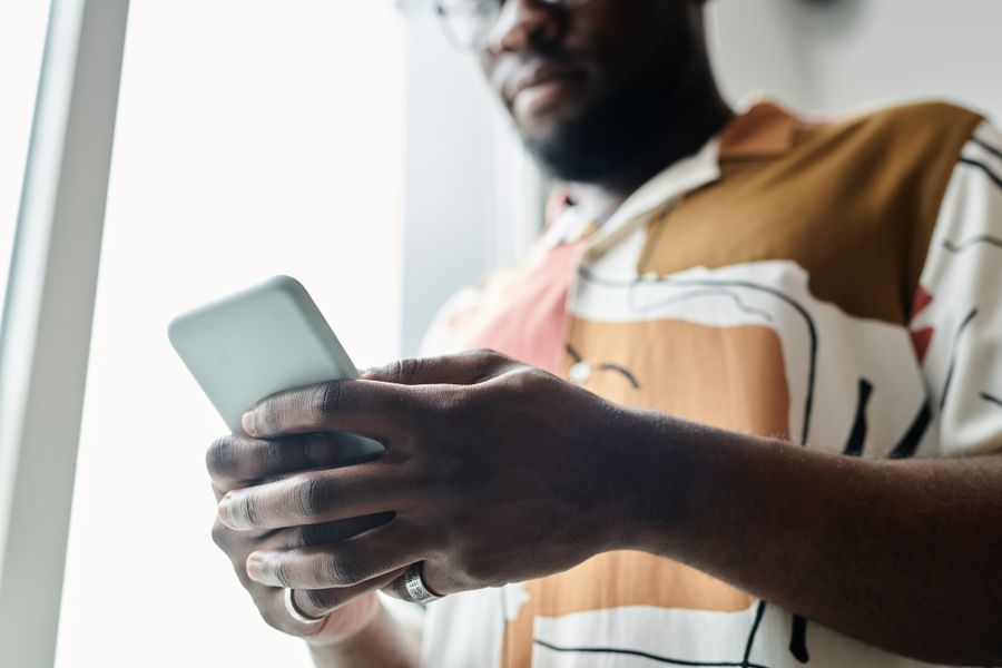 close up shot of a man using a smartphone — No account, no install, no waiting — Public Wi-Fi Security Checklist loads and answers.