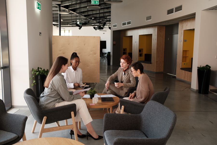 woman sitting at work — Device Compatibility Checker: tell it about the trip, get the answer in under a minute.