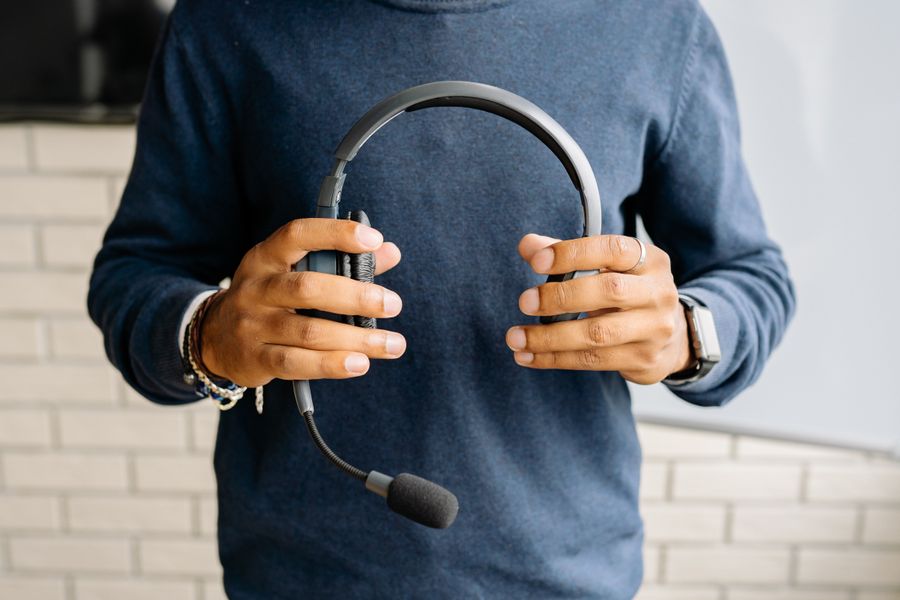 a person holding a headset