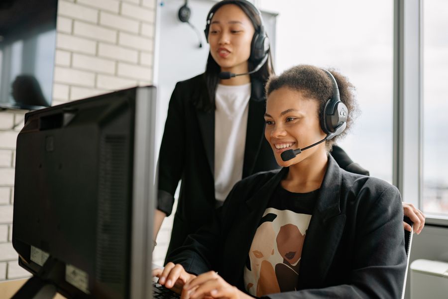 two women with headsets working as call center agents — Coast roads and country lanes — the map keeps up wherever you roam.